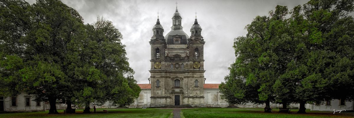 Pazaislis Monastery next to oak trees storm clouds above